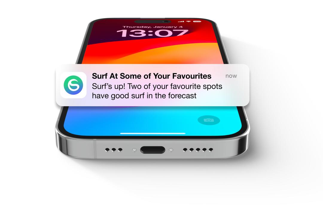 iPhone 15 laying flatshowing Swellify notification